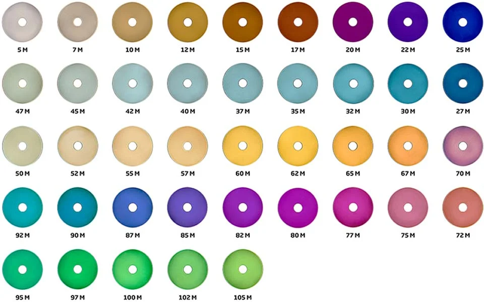 Color anodized titanium medical implants showing color-coded bone screws and dental implants for surgical identification