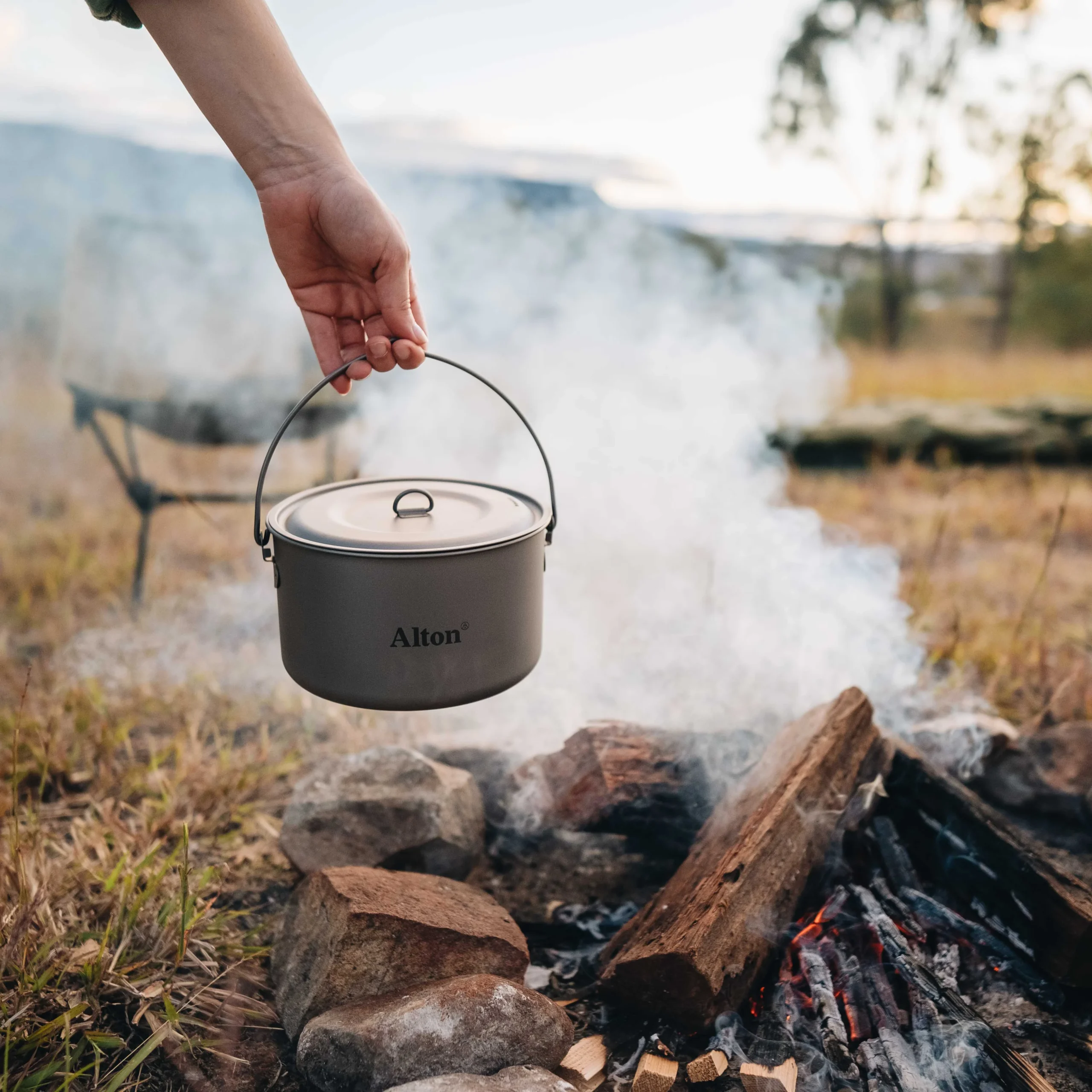 Titanium camping cookware range - well-used titanium pots showing normal heat discoloration after outdoor use