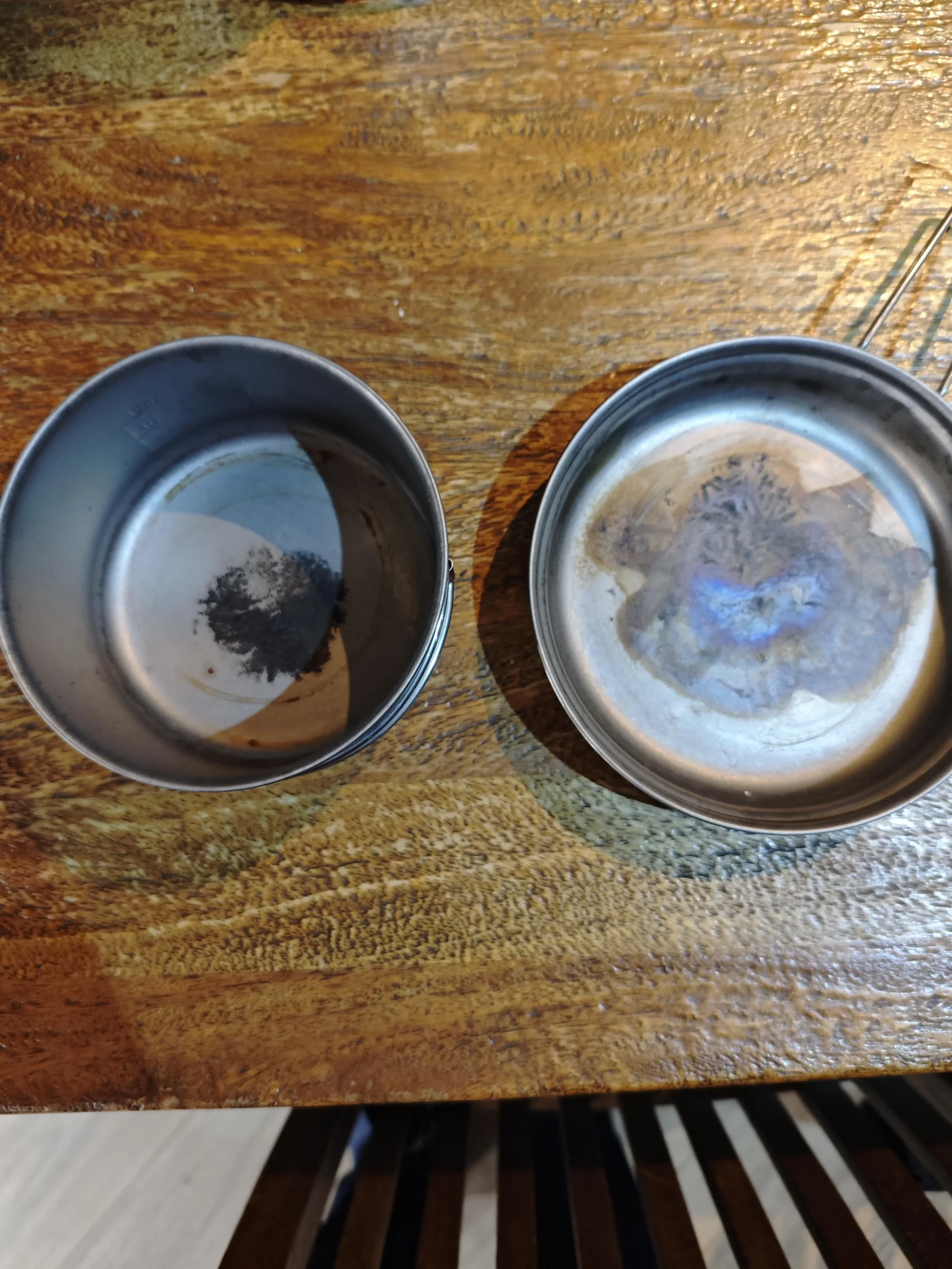 Carbon buildup on titanium camping pot - burnt food residue on interior surface before cleaning