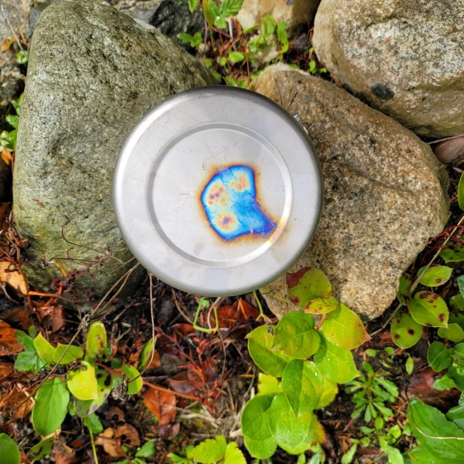 Titanium pot showing rainbow blue purple heat discoloration on the bottom - normal oxide layer formation