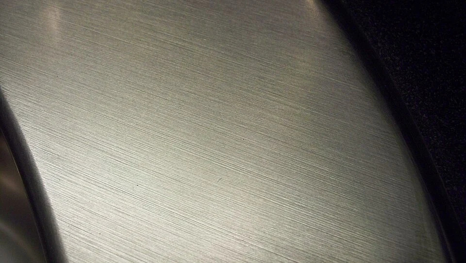 Brushed titanium metal surface texture close-up - Grade 2 commercially pure titanium material