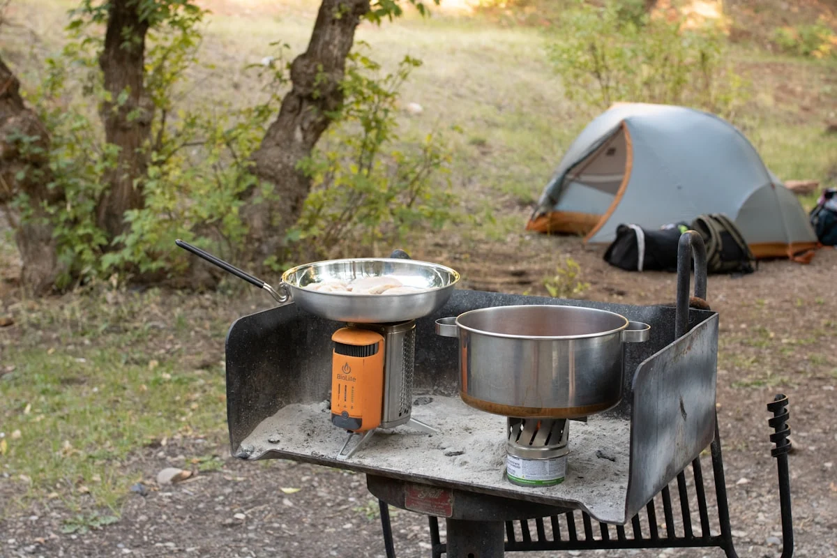 Pure titanium camping cookware on outdoor stove — ultralight titanium pots and pans for backpacking Pure titanium camping cookware on outdoor stove — ultralight titanium pots and pans for backpacking
